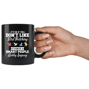 May include: Black ceramic mug with the text "IT'S OK IF YOU DON'T LIKE Bird Watching. IT'S KIND OF A SMART PEOPLE Hobby Anyway." Features colorful bird illustrations. A perfect gift for bird watchers.