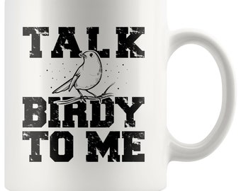 May include: White ceramic coffee mug with a black and white design. The design features a bird with the text "Talk Birdy To Me".
