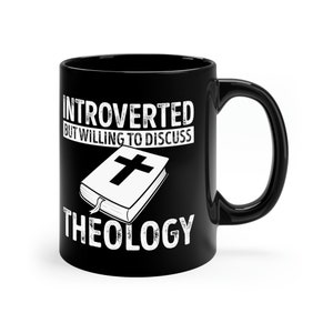 May include: Black coffee mug with white text that reads "Introverted but willing to discuss theology". A white illustration of a closed book with a cross on the cover is above the word "theology".