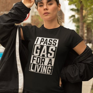 May include: Black t-shirt with a white graphic that says "I PASS GAS FOR A LIVING".