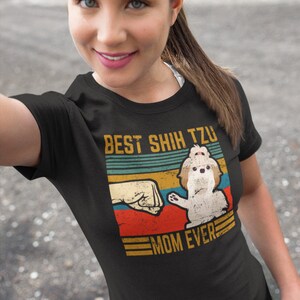 May include: A black t-shirt with a vintage-style graphic featuring a Shih Tzu dog and the text "Best Shih Tzu Mom Ever".