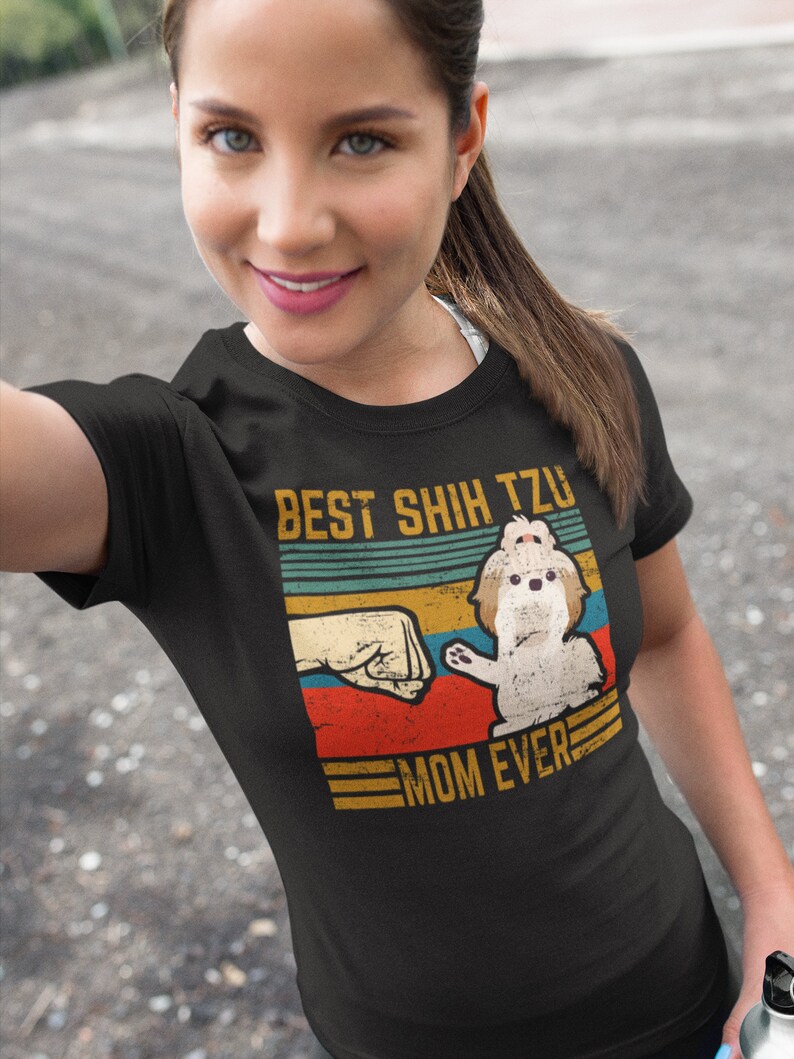 May include: A black t-shirt with a vintage-style graphic featuring a Shih Tzu dog and the text "Best Shih Tzu Mom Ever".