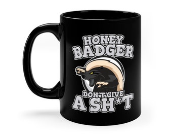 May include: Black ceramic coffee mug with a white graphic of a honey badger with the text "Honey Badger Don't Give A Sh*t".