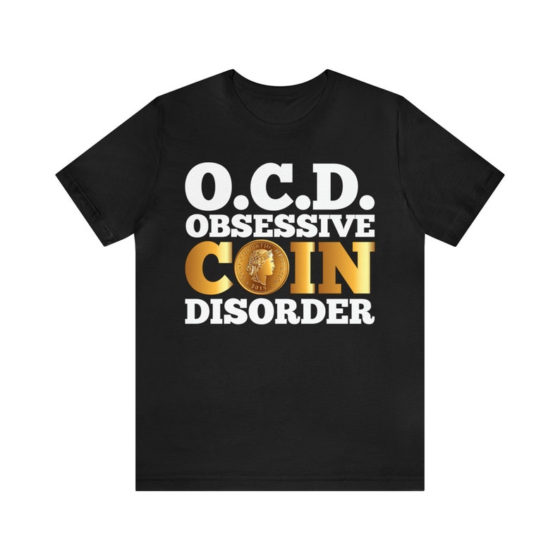 May include: Black t-shirt with white text that reads "O.C.D. OBSESSIVE COIN DISORDER". A gold coin with a woman's profile is in the center of the text.