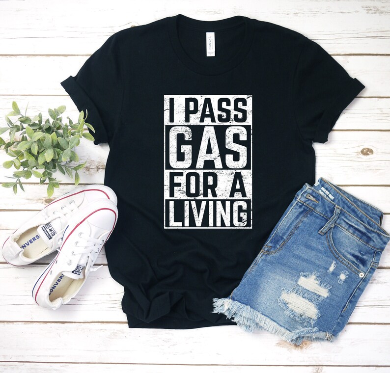 May include: Black t-shirt with white text that reads "I PASS GAS FOR A LIVING".