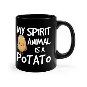 May include: Black coffee mug with white text that reads "My spirit animal is a potato" and a cartoon potato with a smiling face.