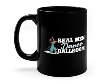 May include: Black ceramic mug with a white design that says "Real Men Dance Ballroom" and a silhouette of a couple ballroom dancing.