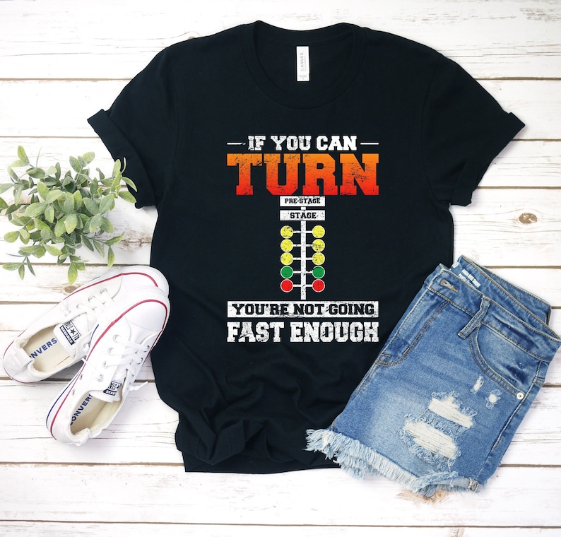 May include: Black t-shirt with a white graphic of a drag racing Christmas tree with the text "If you can turn you're not going fast enough".