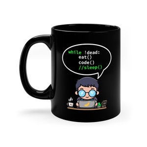 Può includere: Tazza da caffè nera con un'illustrazione di un cartone animato di una persona che codifica. La tazza presenta il testo "while !dead: eat() code() //sleep()" in caratteri di codice verdi.