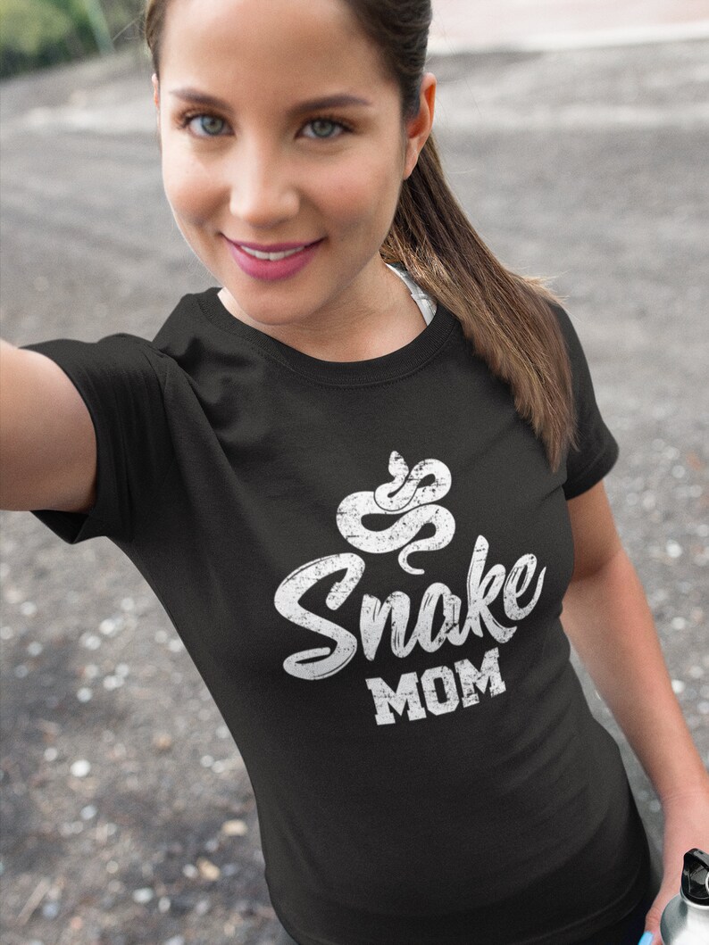 May include: A black t-shirt with a white snake graphic and the text "Snake Mom" in a distressed font.