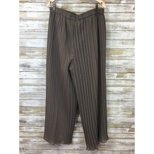 May include: Brown pleated wide-leg pants with a drawstring waist.