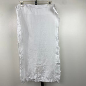 May include: White linen pillowcase with a small embroidered square in the center.