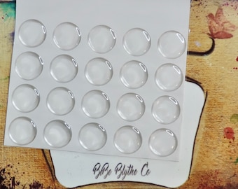 May include: A sheet of clear, round, adhesive stickers on a white background. The sheet has 20 stickers arranged in a 4x5 grid. The sheet is labeled "Bbz Blythe Co."