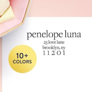 May include: A pink and gold-rimmed dish holds several light-colored, geometric-shaped candies. The text "penelope luna" is displayed with an address below it. A yellow circle with "10+ COLORS" is also present.