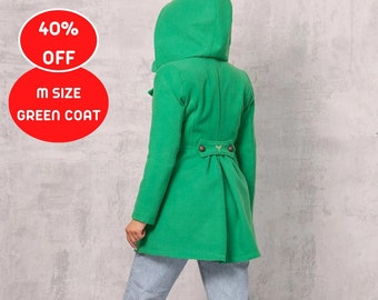 May include: A green hooded coat with a button closure and a small butterfly design on the back. The coat is being worn by a person with light blue jeans and black boots.