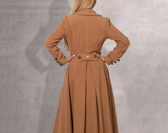 May include: A long brown coat with a high collar, a belt, and a pleated skirt.