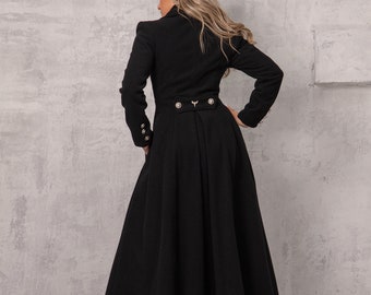 May include: A black long coat with a high collar and a flared skirt. The coat has gold buttons and a gold belt buckle.