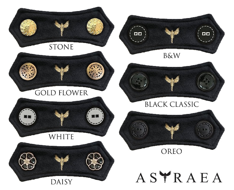 May include: Set of 10 black fabric face mask extenders with different colored buttons. The extenders feature a gold embroidered butterfly design. The buttons include gold, silver, black, and white.
