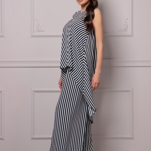 May include: A black and white striped jumpsuit with a ruffled hem.