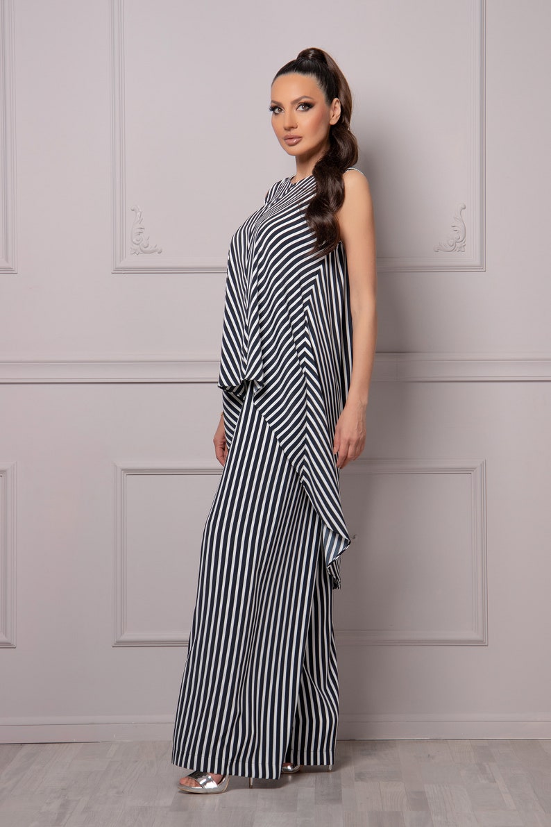 May include: A black and white striped jumpsuit with a ruffled hem.