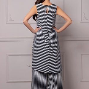 May include: A black and white striped sleeveless dress with a V-neckline and a matching pair of wide-leg pants.