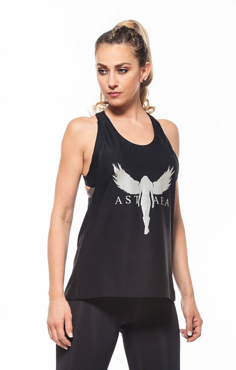 May include: Black tank top with a silver graphic of a woman with wings and the text "ASTA AEA".