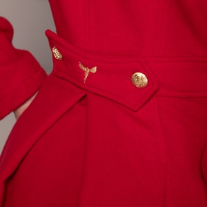 May include: A red coat with a gold button and a gold embroidered dragonfly on the waist.