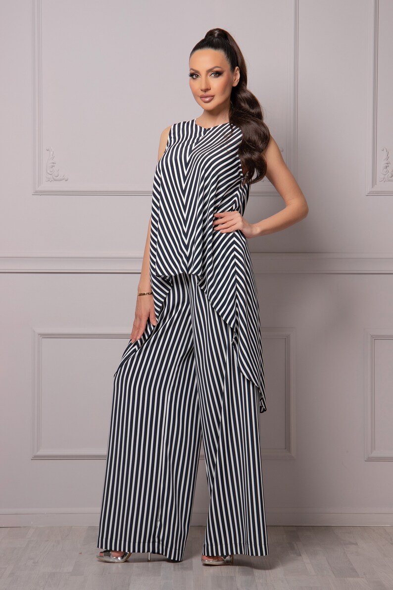 May include: A black and white striped jumpsuit with a sleeveless top and wide-leg pants.