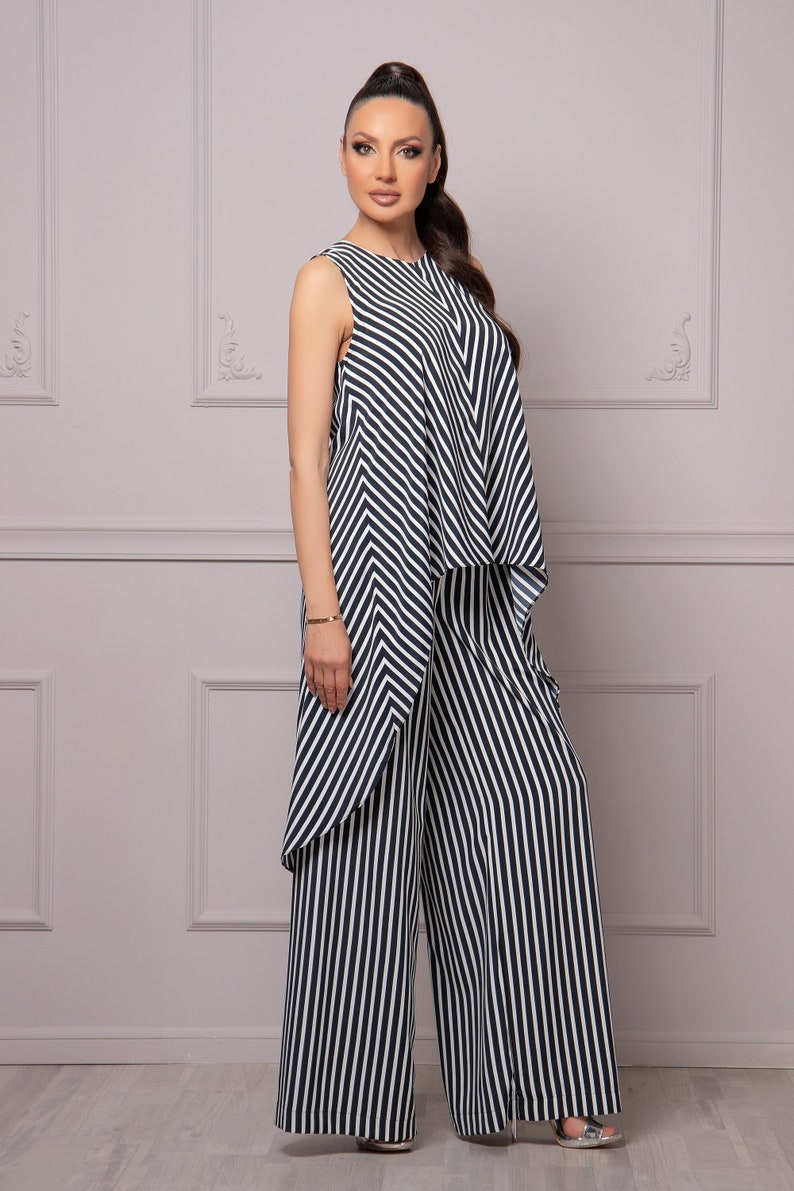 May include: A black and white striped jumpsuit with a wide-leg pant style.