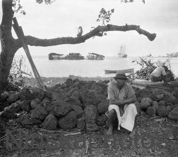 1920s Apia, Samoa - Man sitting on shore with wreck of German Gunboat in background, antique photo reprint, military history