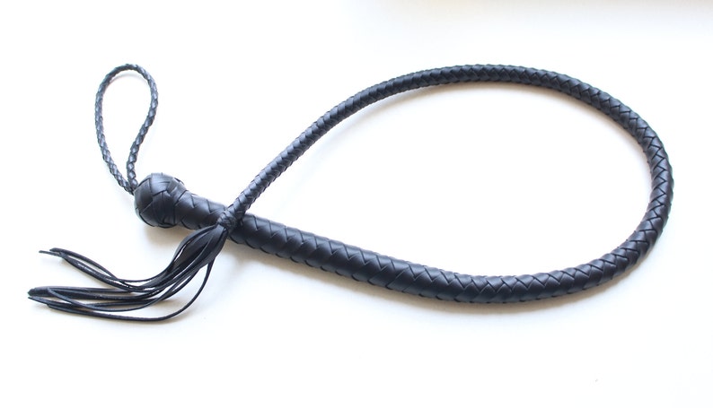 May include: A black leather bullwhip with a braided handle and a tassel.