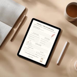 May include: A digital tablet displaying a "February - Flow & Gentle Focus" form, with a notebook, pen, cup of tea, and a lit candle. The scene is set on a beige surface, with soft shadows.