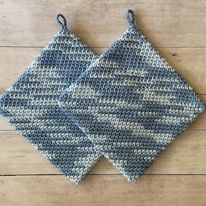 May include: Two blue and white crocheted pot holders with a hanging loop.