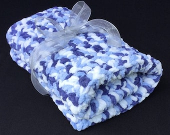 May include: A soft, blue, white, and purple baby blanket with a white satin ribbon tied around it.