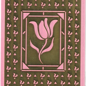 May include: Embossing stencil with a pink tulip design, question marks, and triangles on a gold background. The stencil is on a pink and yellow card with the word "Embossing" at the top.
