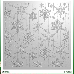 May include: A square embossing folder featuring a repeating pattern of various snowflake designs and vertical hanging lines. The surface is white with a raised texture. The text JND492 and 1 Folder are printed in the bottom corners of the frame.