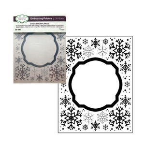 May include: An embossing folder with a snowflake design. The folder is white with black snowflake patterns and a central, decorative frame. The packaging includes the text "EVE'S SNOWFLAKES" and "Embossing Folders by Sue Wilson".