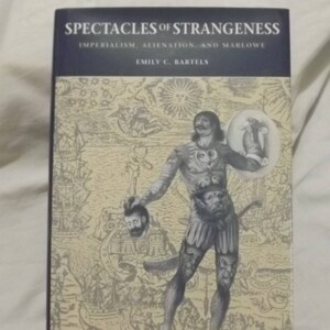 May include: A book titled "Spectacles of Strangeness: Imperialism, Alienation, and Marlowe" by Emily C. Bartels. The cover features an illustration of a man with tattoos and a severed head in his hand.