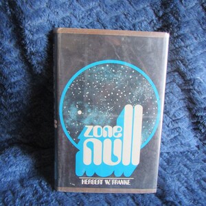 May include: A black and blue paperback book with the title "Zone Null" by Herbert W. Franke. The cover features a blue circle with a starry night sky and the title in white letters.