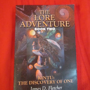 May include: The Lore Adventure book cover, book two, titled "Kintu: The Discovery of One" by James D. Fletcher. The cover features a dark background with a raven perched on a stone pedestal, surrounded by swirling patterns and a bright orange orb.