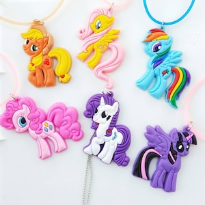 May include: Six colorful My Little Pony character charms, each with a different color and design. The charms are made of rubber and have a shiny finish. They are perfect for adding a touch of whimsy to any necklace, bracelet, or keychain.