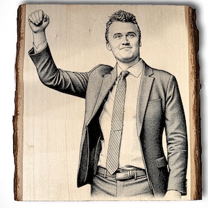 May include: A black and white illustration of a person in a suit with their fist raised. The image is printed on a piece of wood with a natural edge. The person is wearing a suit, tie, and dress shirt.
