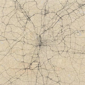 May include: A detailed map of a city's road network, rendered in black lines against a beige background. The intricate network of roads and highways creates a complex pattern, with a central urban area and surrounding suburban areas.