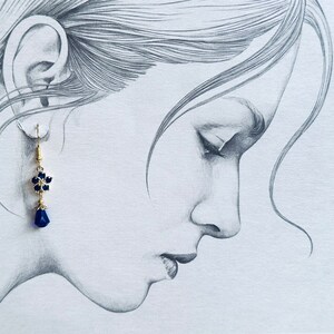These gorgeous sapphire crystal flower teardrop earrings work well with many different fashion styles and makes a great gift for those born under the September birthstone. 

2  inches
Gold ear wires
Rubber security backs