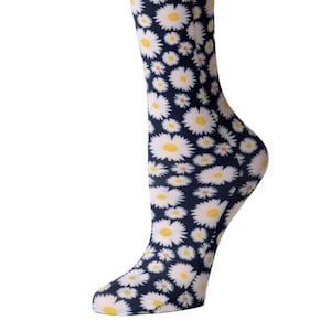 May include: A pair of knee-high compression socks with a white daisy pattern on a dark blue background.