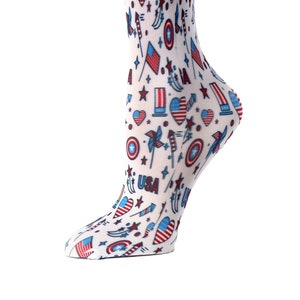 May include: White knee-high socks with a red, white, and blue pattern featuring stars, hearts, fireworks, and the word "USA".