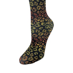 May include: Black knee-high compression socks with a leopard print pattern in shades of yellow, orange, and red.