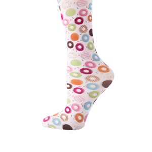 May include: A white sock with a colorful donut pattern. The donuts are in various colors, including pink, orange, green, and brown, with sprinkles. The sock is knee-high and has a rounded toe.