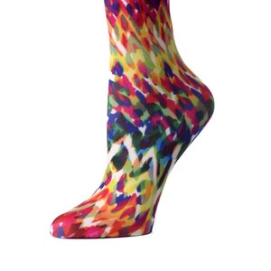 May include: A pair of colorful knee-high socks with a bright abstract pattern in shades of red, yellow, blue, green, and white.