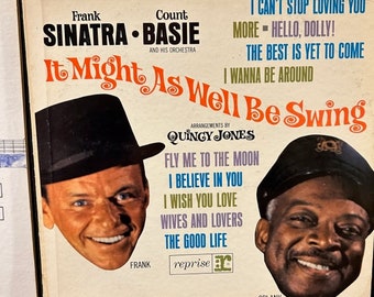 May include: Vintage vinyl record album cover for "It Might As Well Be Swing" by Frank Sinatra and Count Basie. The cover features portraits of the artists and song titles like "Fly Me to the Moon".